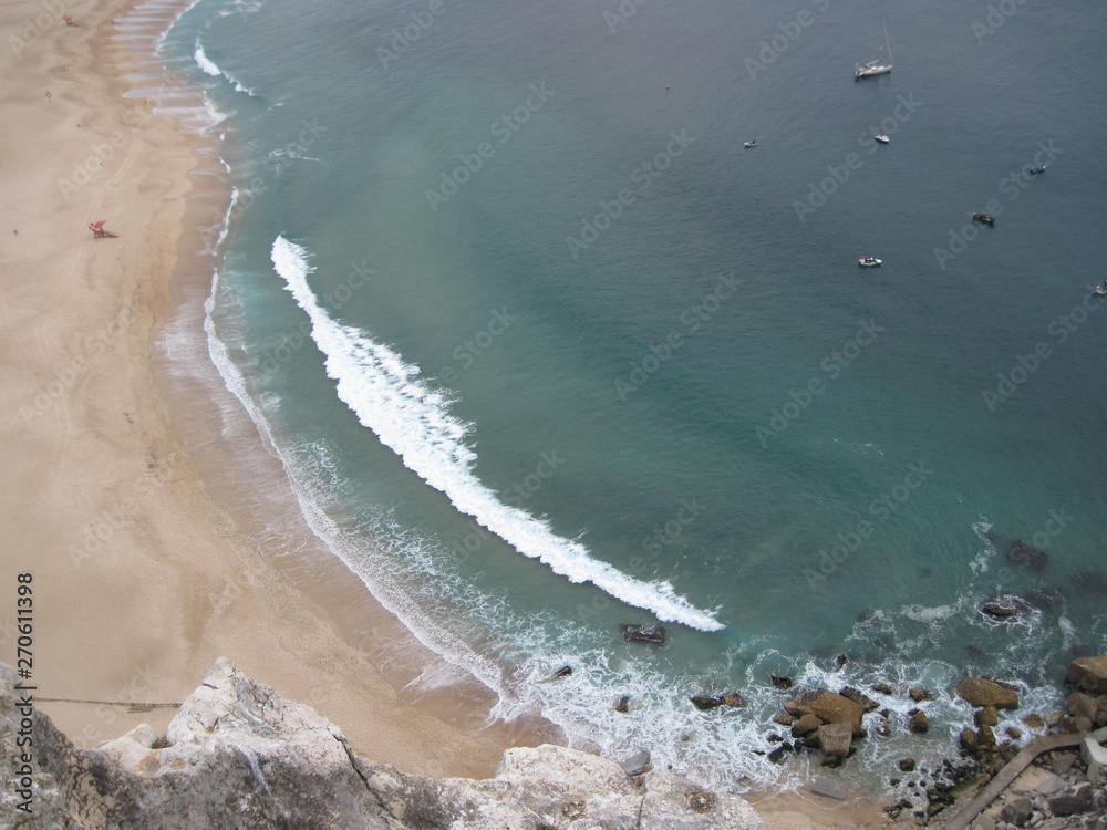 view of beach with waves crashing on beach