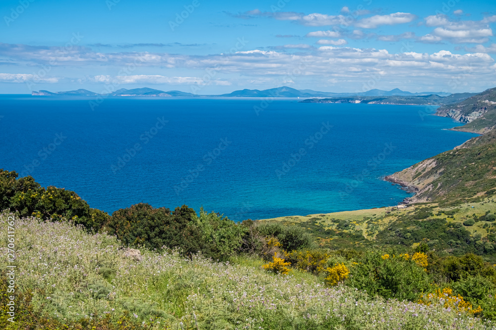 Spectacular landscapes, awe-inspiring cliffs, charming villages and historical landmarks along the coastal road between Alghero and Bossa (SP 105), Sardinia, Italy.