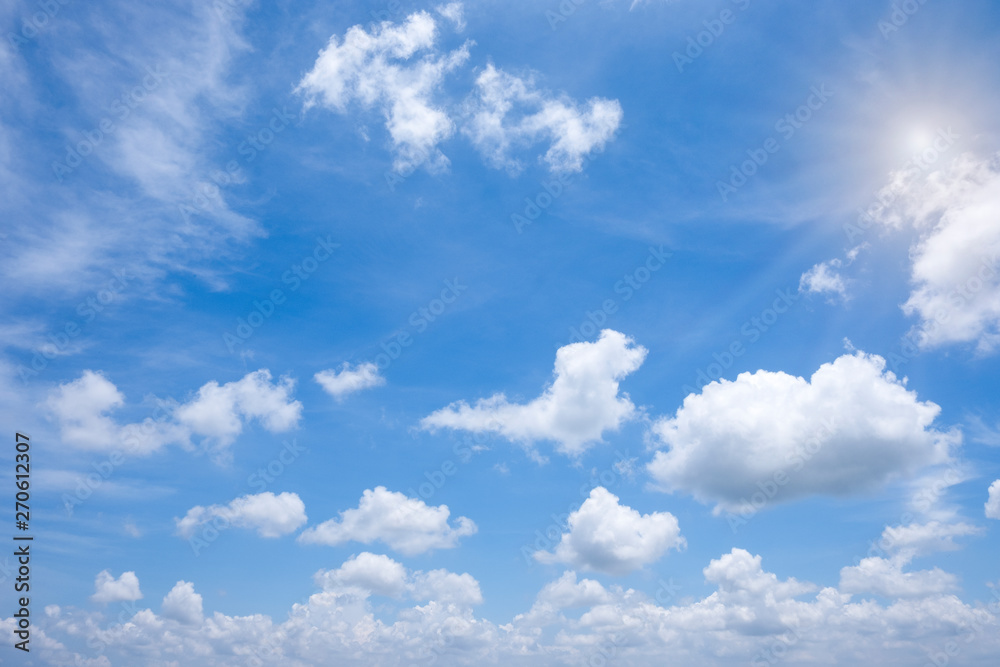Beautiful white clouds with sun on blue sky.Color shade gradient from white to blue for background wallpaper.
