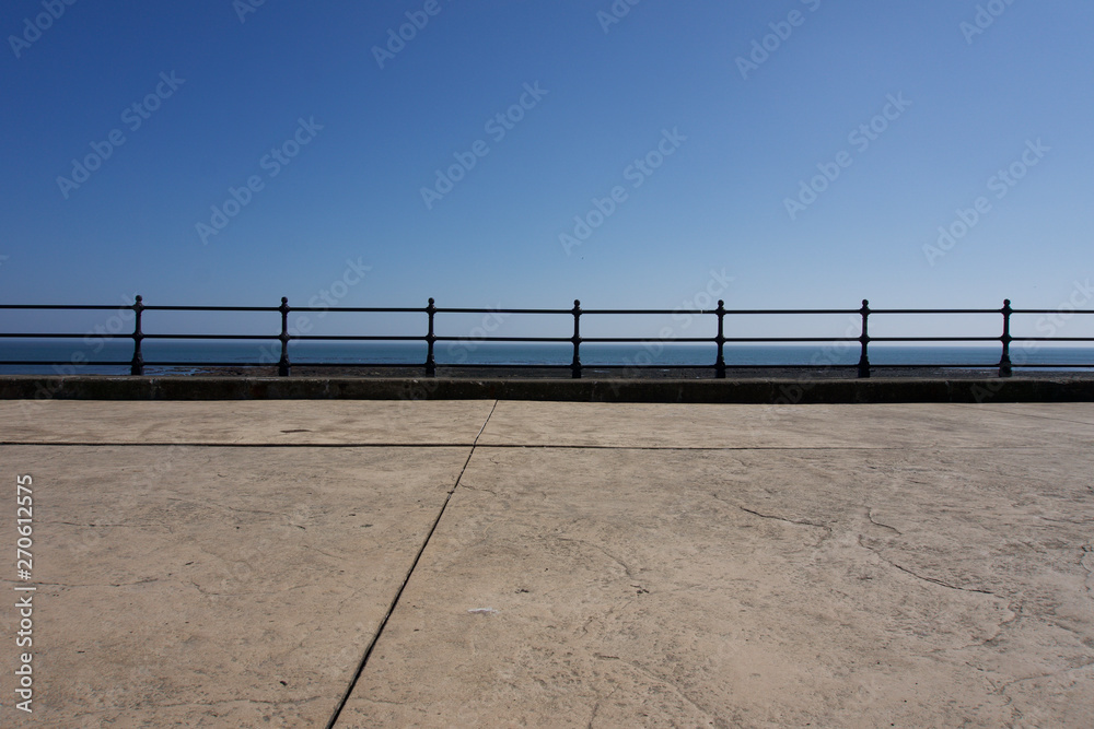 Railings along promenade at Scarborough under a clear blue sky