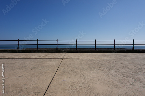 Railings along promenade at Scarborough under a clear blue sky