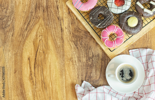 Donuts and coffee on wooden table, top view