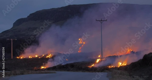 Wildfire near powerlines on the hillside.