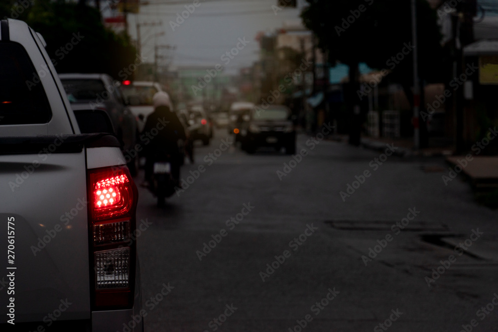 Blurred image of Cars on the road in traffic junction at evening. Open light.
