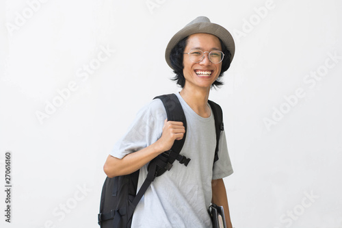 portrait of Happy smiling college student with book and bag isolated on white background