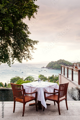 Sea view terrace or outdoor deck with contemporary dining table © PixHound