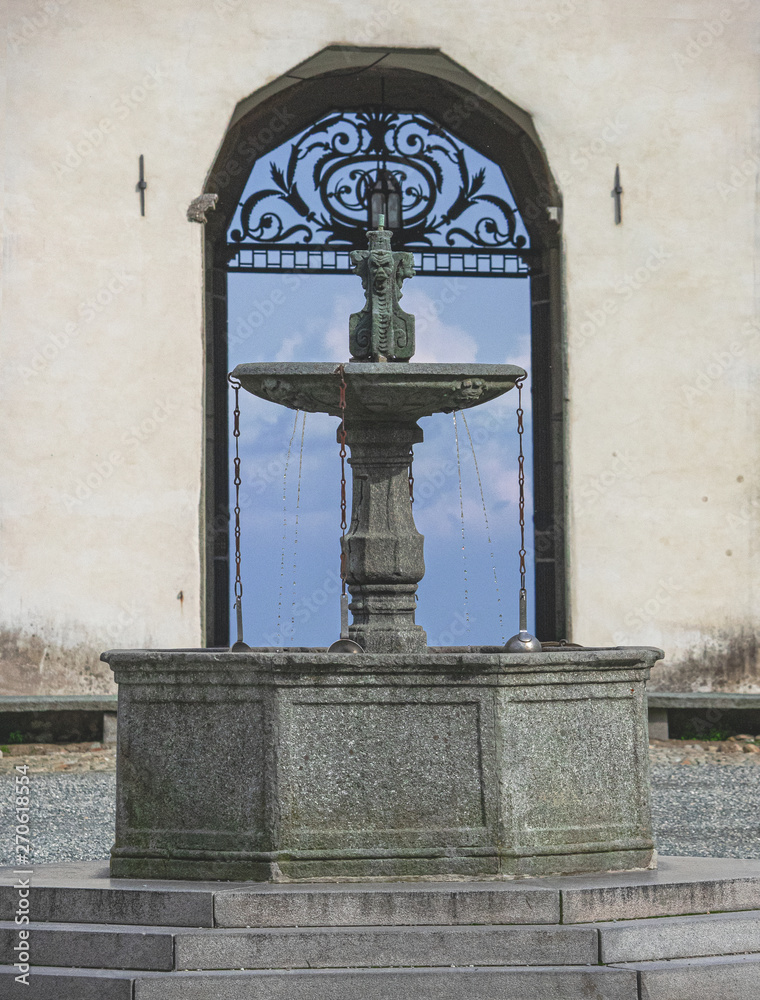 fountain to quench the thirst for pilgrims with panoramic views of the Alps fountain to quench the thirst for pilgrims with panoramic views of the Alps