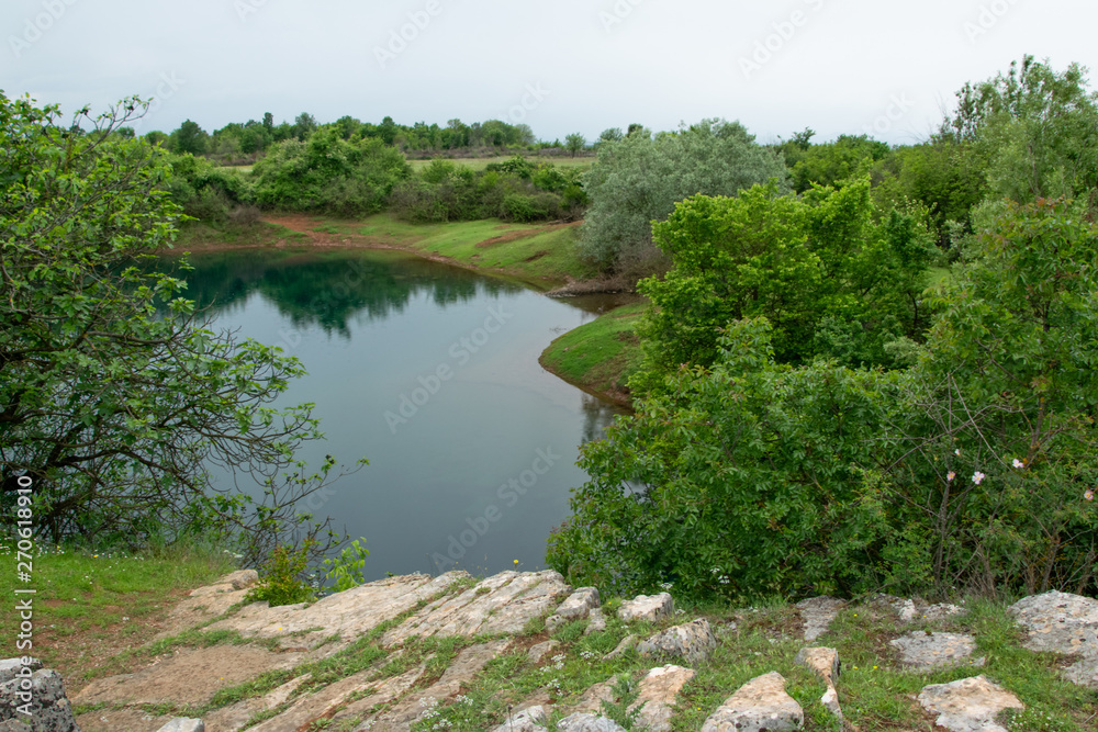 Peaceful landscape view of lake hidden in the lush nature, Shegan's Eye, Albania