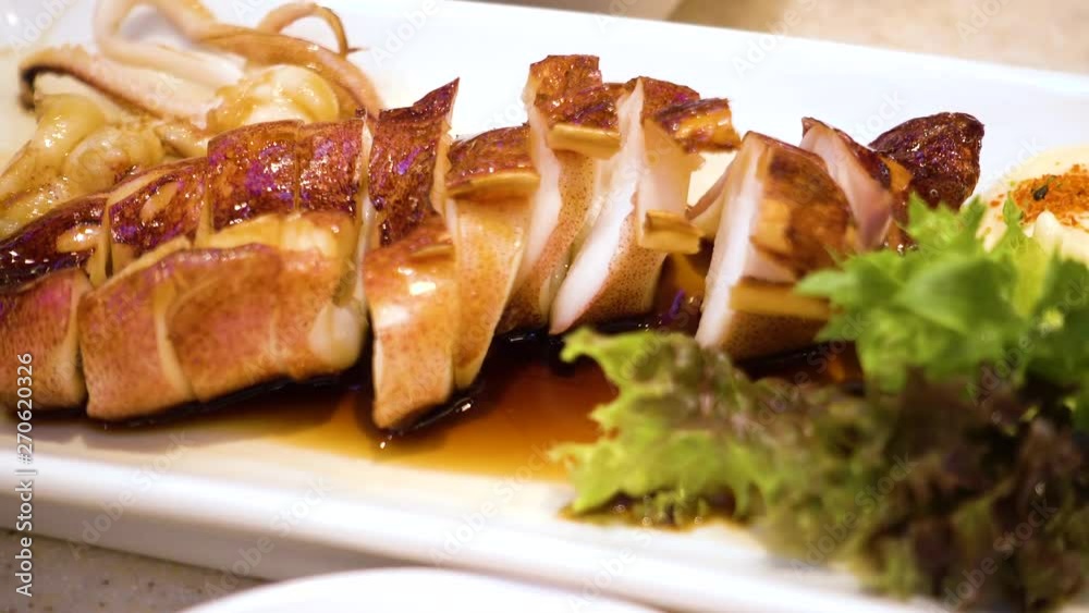 Grilled squid sauce in white dish with vegetable, Japanese food Grilled squid sauce in white dish with vegetable, Japanese food