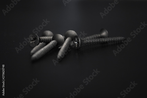 screws on black background