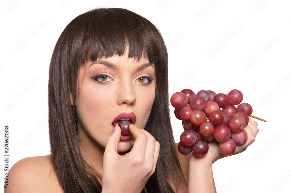Portrait of young woman posing with grapes on white background Portrait of young woman posing with grapes on white background