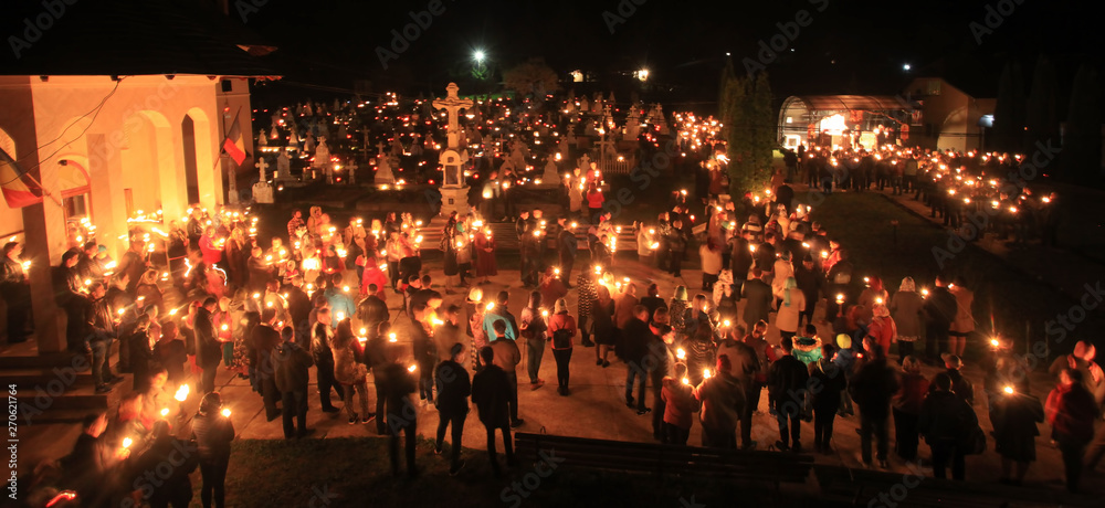 people with light and candles in the night. Orthodox church scene, Romania