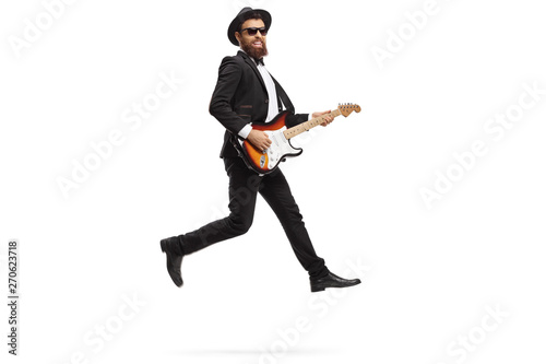 Man performing with an electric guitar and jumping