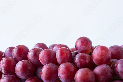 Red grapes on white background. Top view. Bunch of grape on white background. Pink bunch grape on white.
