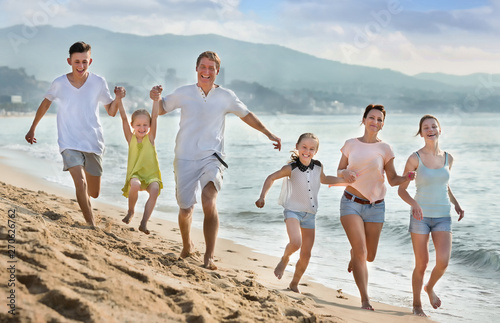 Parents children running on beach