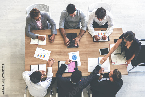 Top view businessman and businesswoman having a meeting and making a business commitment.