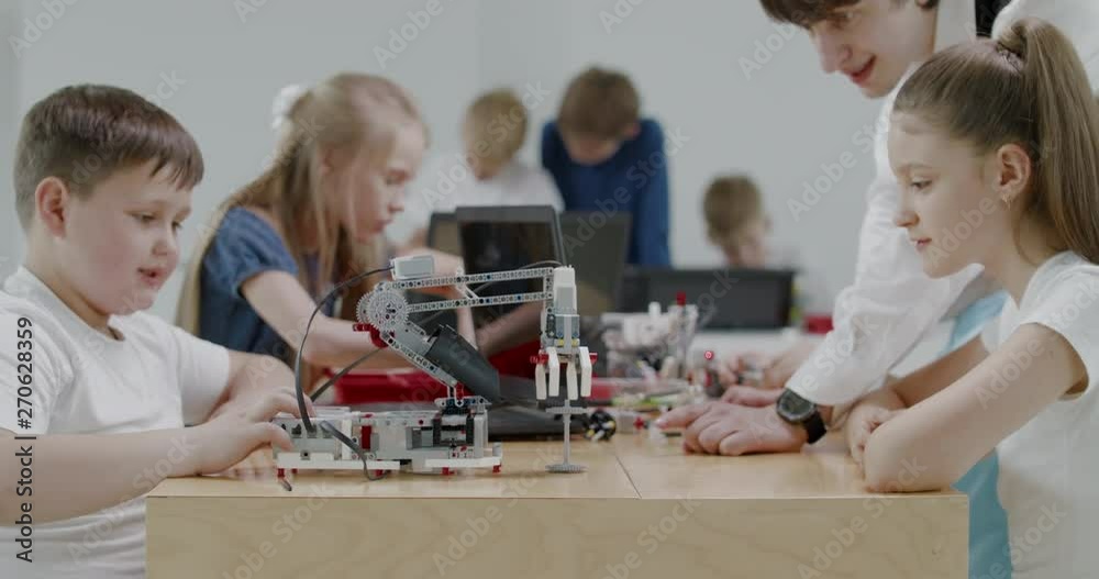 Curious kids working on a functional programable robot during robotics class at school. 4K UHD 60 FPS SLOW MOTION