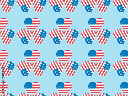 seamless background pattern with hearts made of usa flags on blue