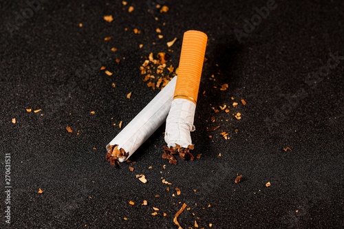 stop smoking concept, a broken cigarette isolated against black, World Tobacco Day