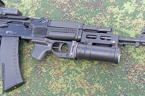 modern assault rifle with underbarrel grenade launcher photo