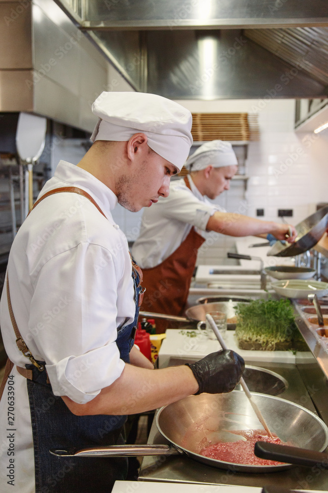 Cooks working in restaurant Cooks working in restaurant