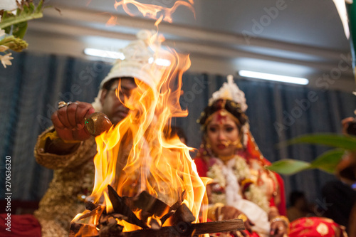 Bride and groom performing Hindu rituals in a marriage ceremony