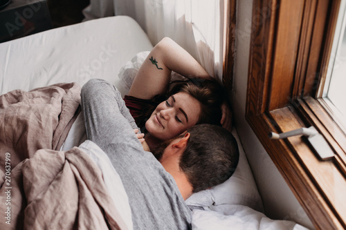 Couple Waking Up In Bed Together