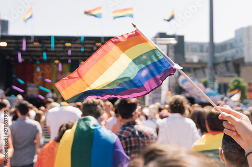 People With Rainbow Flags Attending a Gay pride photo