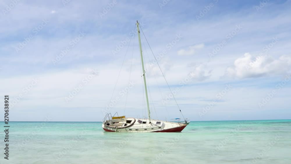 Caribbean yacht stranded boat on the side blue sea and blue sky summer vacati Caribbean yacht stranded boat on the side blue sea and blue sky summer vacati