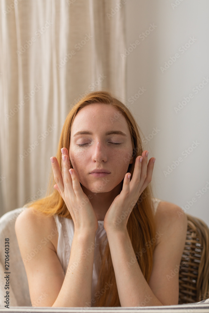 Portrait of woman applying cream on her face Portrait of woman applying cream on her face