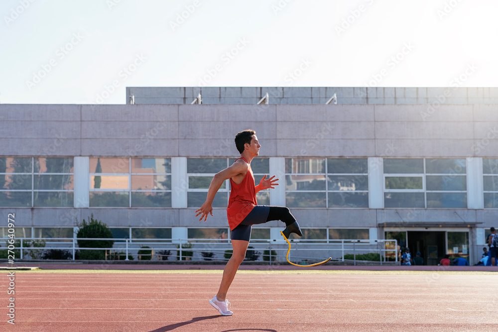 Disabled man athlete training with leg prosthesis Disabled man athlete training with leg prosthesis