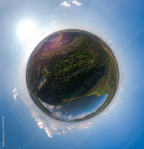 Little planet. Young trees, plantations on the slopes. Aerial view on the Dniester Canyon, River, Bakota Bay in National Park Podilski Tovtry. Ukraine.