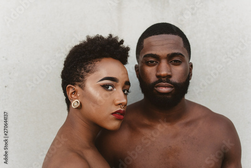 A young black couple facing each other photo