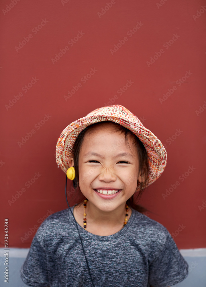 Pretty Asian little girl expression. Ancient architecture wall background Pretty Asian little girl expression. Ancient architecture wall background