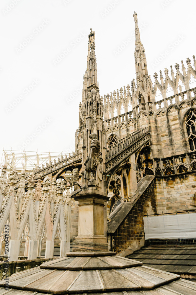 Flying buttress and ornately carved stonework on the roof of the Duomo di Milano (Milan Cathedral), Italy