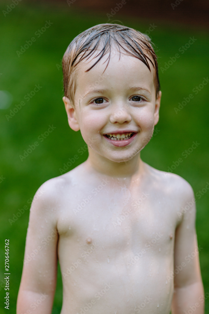 Portrait of a water soaked young boy smiling Portrait of a water soaked young boy smiling