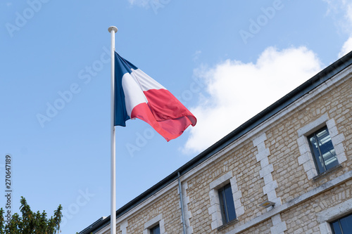 french flag at the top of a mat in a barracks blue white red photo
