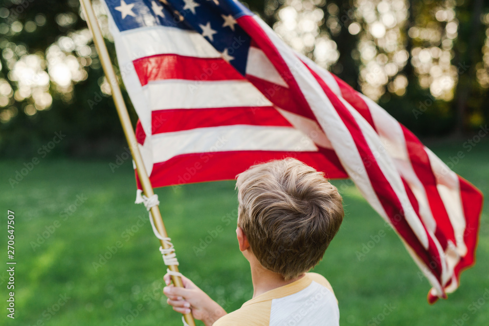 anonymous boy holding an American flag Stock Photo | Adobe Stock