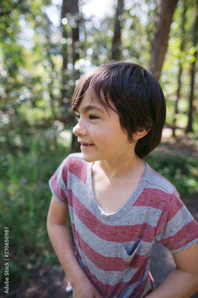 Healthy, smiling boy exploring nature in the woods Healthy, smiling boy exploring nature in the woods