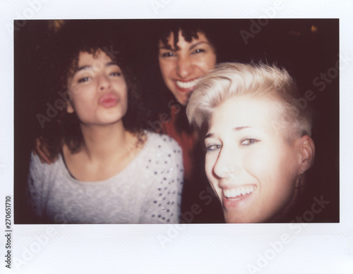 Polaroid selfie of ladies having fun together at night.