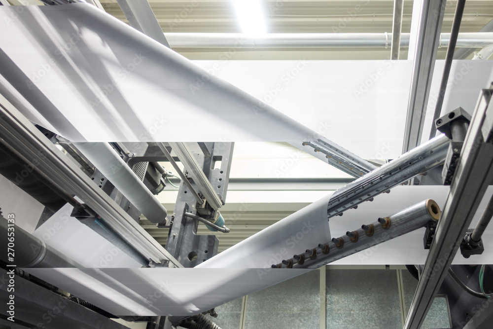 Folding Machines in Printing Production Factory Industrial Equipment Detail Closeup Folding Machines in Printing Production Factory Industrial Equipment Detail Closeup