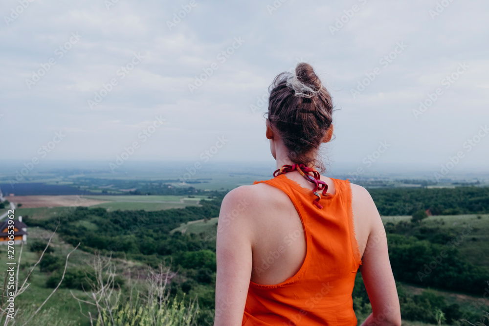 Female model from back looking at a beautiful view Female model from back looking at a beautiful view
