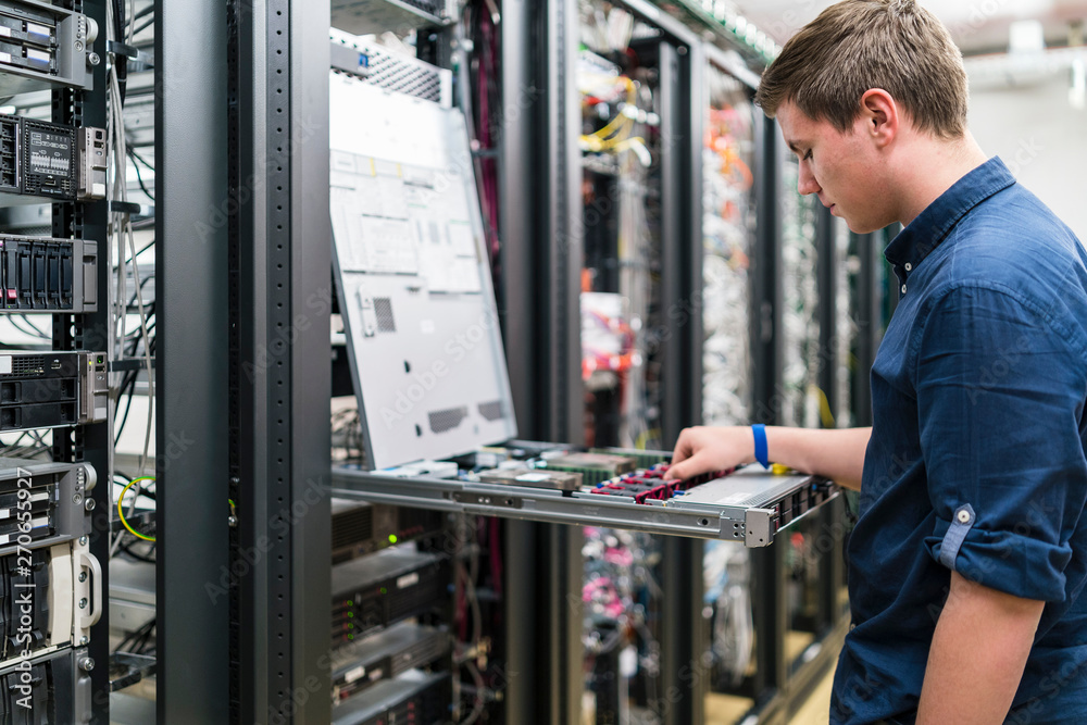 © Westend61 - Teenager working in server room © Westend61 - Teenager working in server room