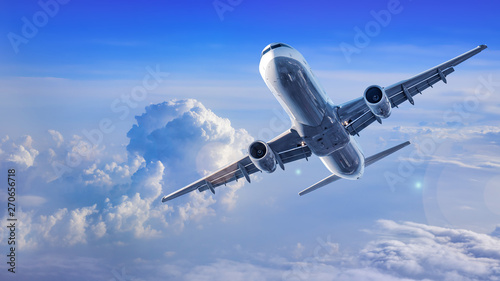 modern airliner flies between clouds photo