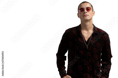 Half length portrait of young confident and succesful male enterpreneur in black shirt and red sunglasses, with short haircut, looking at the camera, copyspace for your text