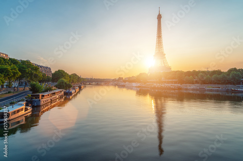 Eiffel Tower reflection on river Seine while sunrise