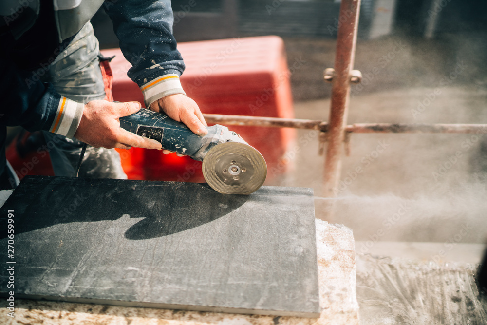 Close up details of worker cutting stone marble with angle grinder at  construction site Stock Photo | Adobe Stock