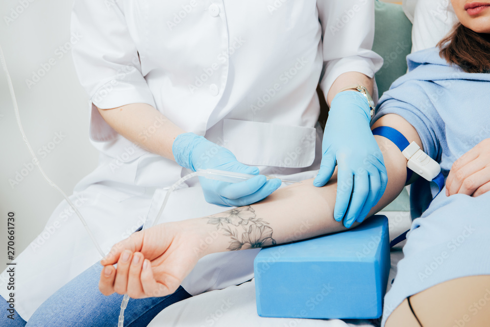 cropped view of doctor in latex gloves doing injection in hospital cropped view of doctor in latex gloves doing injection in hospital
