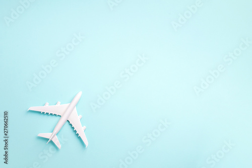 White plane, airplane on blue pastel color background with copy space. Top view, flat lay. Minimal style design. Travel, vacation concept