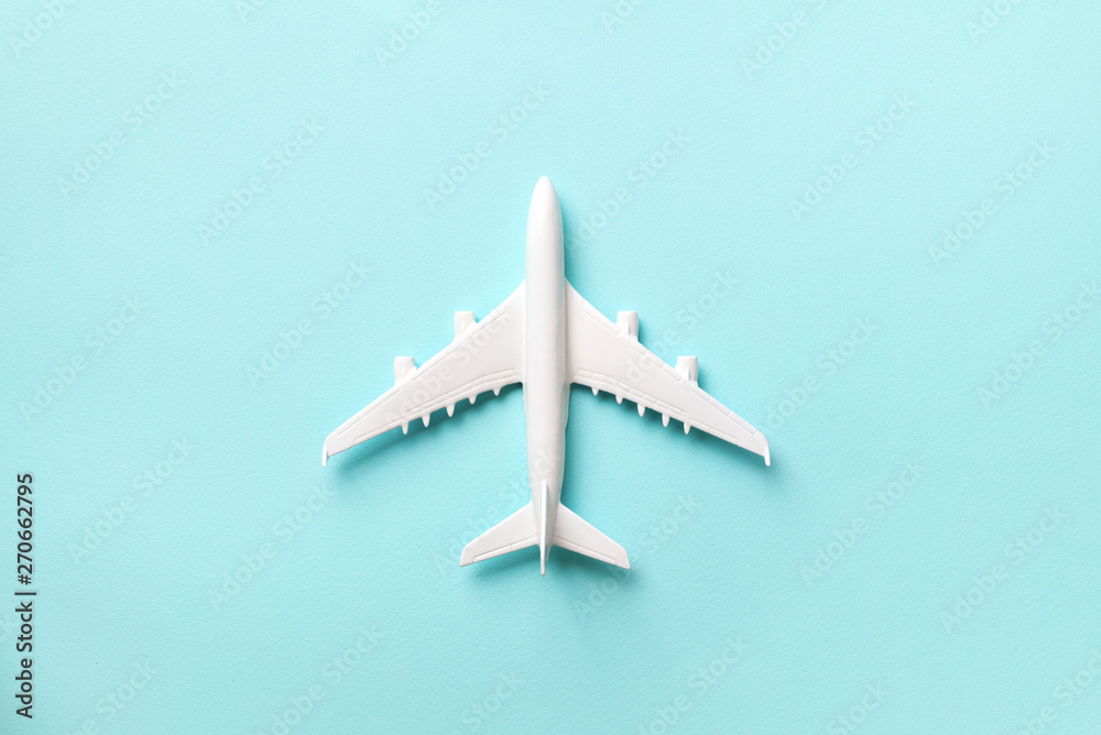 Creative layout. Top view of white model plane, airplane toy on pink pastel background. Flat lay with copy space. Trip or travel banner Creative layout. Top view of white model plane, airplane toy on pink pastel background. Flat lay with copy space. Trip or travel banner